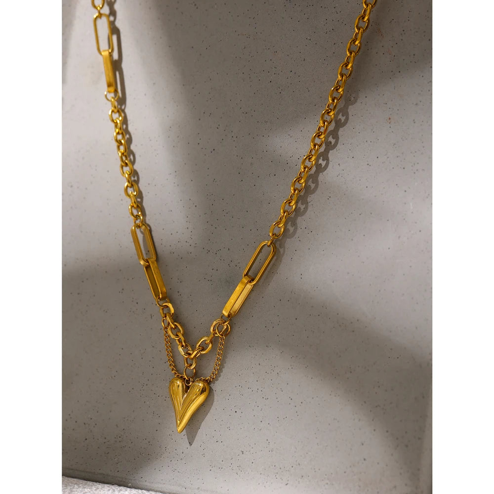 Elegant gold necklace featuring a unique heart-shaped pendant.