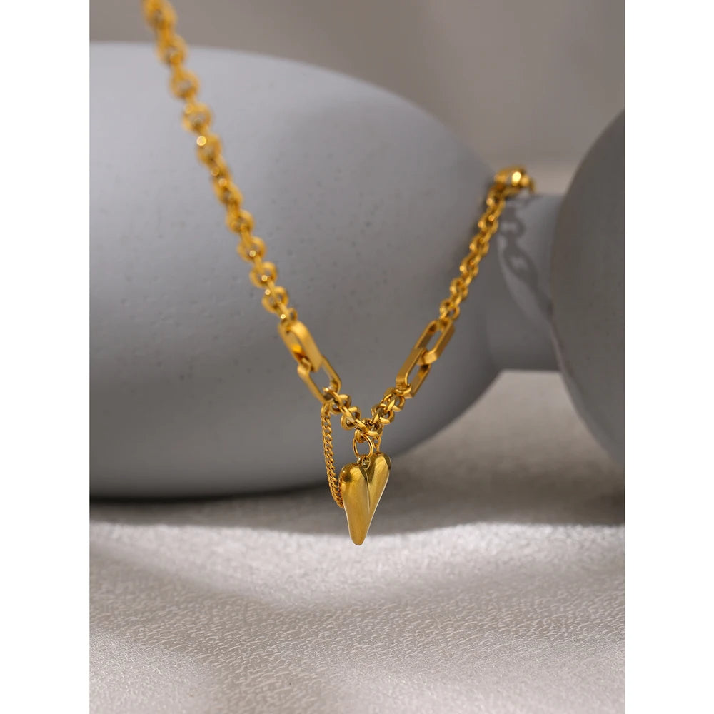 Elegant gold necklace featuring a unique heart-shaped pendant.